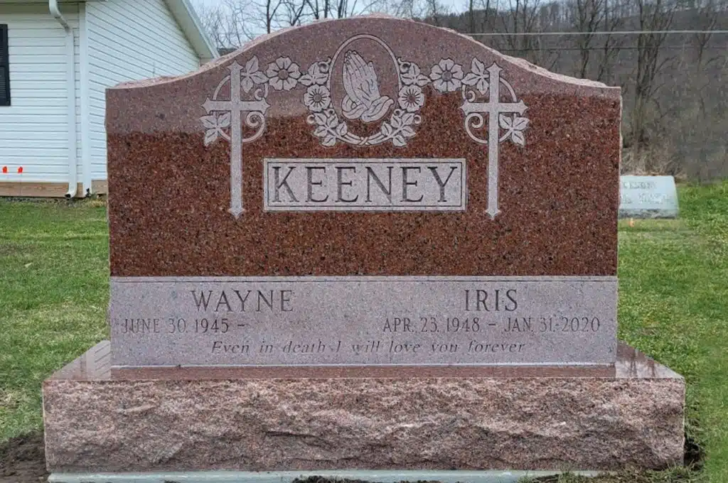 upright monument double cross praying hands